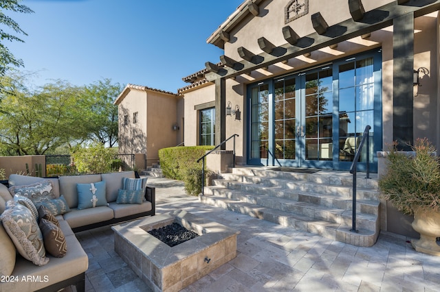 view of patio / terrace with an outdoor living space with a fire pit