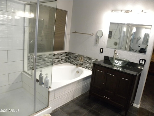 bathroom with tile flooring, vanity, and independent shower and bath