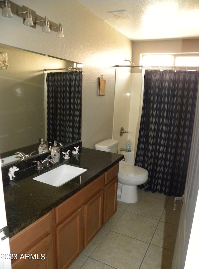 full bathroom featuring toilet, vanity, tile flooring, and shower / bath combination with curtain