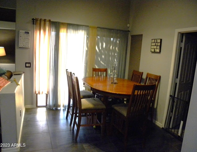 dining area featuring dark tile floors and a healthy amount of sunlight