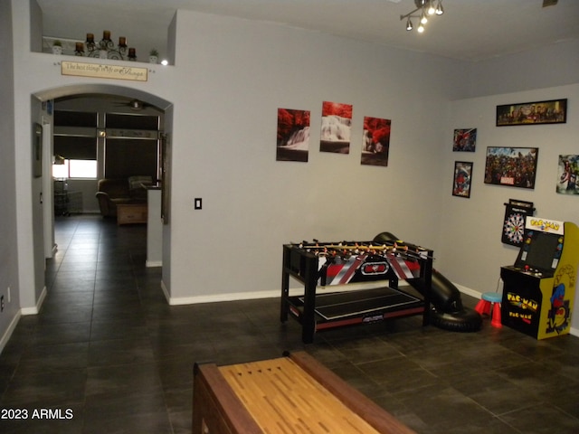 interior space featuring dark tile flooring and rail lighting