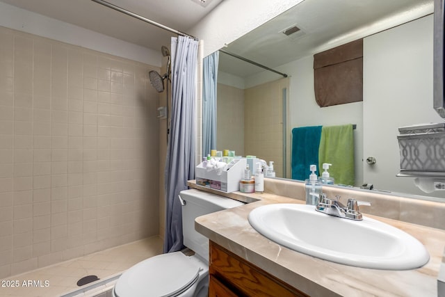 bathroom with a shower stall, visible vents, vanity, and toilet