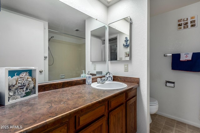 bathroom with visible vents, toilet, vanity, tile patterned flooring, and walk in shower