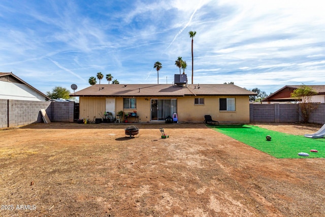 rear view of house with a fenced backyard and central air condition unit