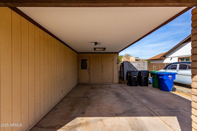 view of patio featuring a carport and fence