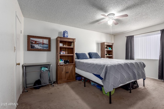 bedroom with a ceiling fan, a textured ceiling, and light colored carpet