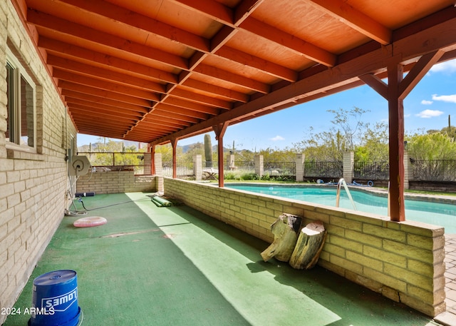 view of patio / terrace with a fenced in pool