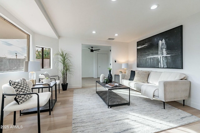 living room featuring ceiling fan and light wood-type flooring