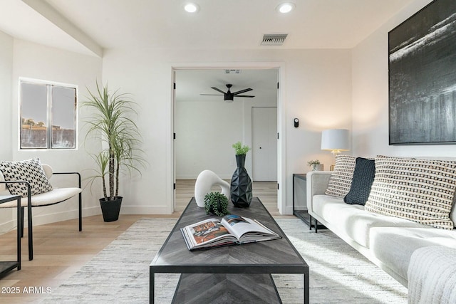 living room with ceiling fan and light wood-type flooring