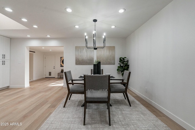 dining area featuring a chandelier and light wood-type flooring