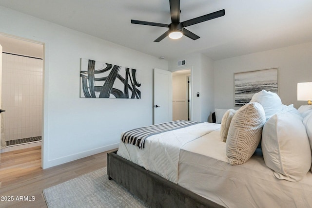 bedroom with light hardwood / wood-style floors, ceiling fan, and ensuite bathroom