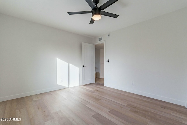 empty room with ceiling fan and light hardwood / wood-style floors