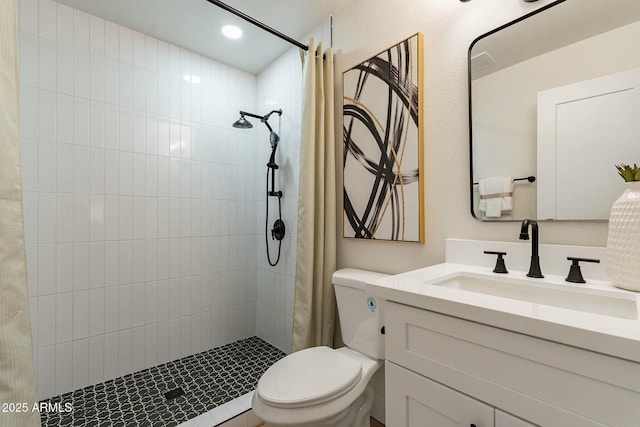 bathroom featuring a shower with shower curtain, vanity, and toilet