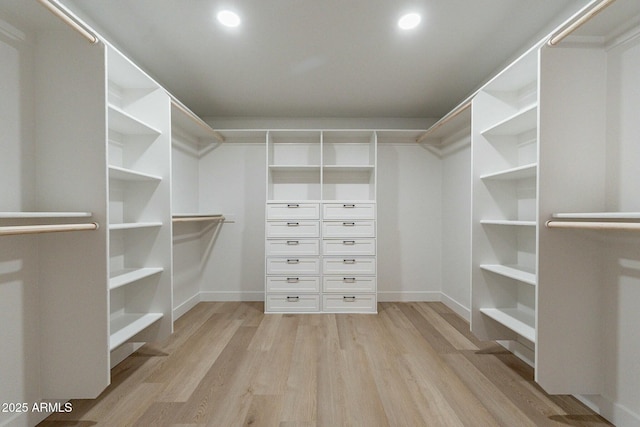 walk in closet with light wood-type flooring