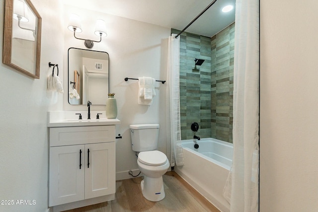 full bathroom featuring shower / bath combo with shower curtain, vanity, hardwood / wood-style floors, and toilet