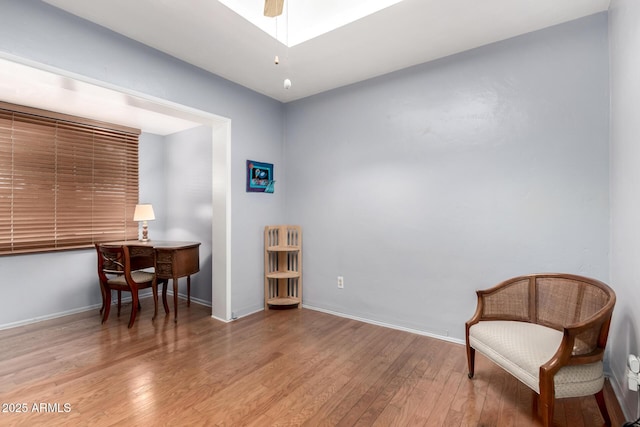 sitting room featuring baseboards and wood finished floors