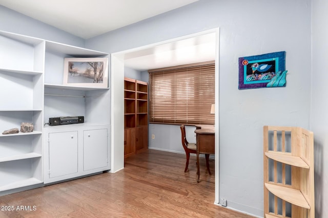 interior space featuring baseboards and light wood-type flooring
