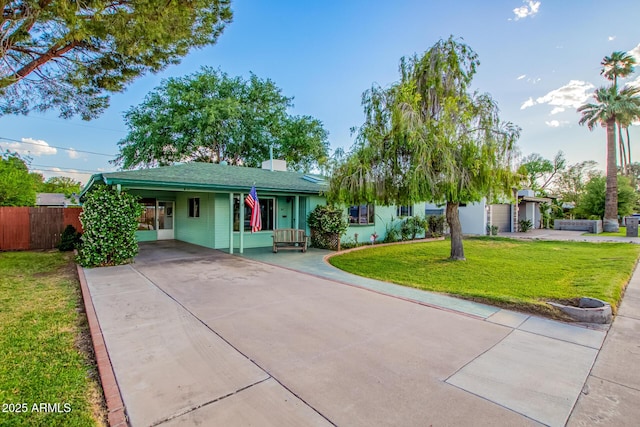 single story home with fence, driveway, a front yard, and a carport