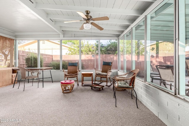 sunroom with beamed ceiling and a ceiling fan