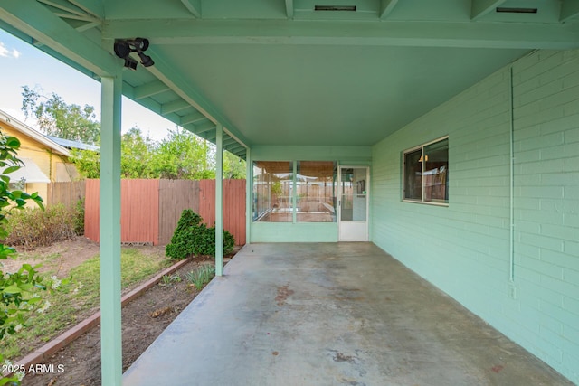 view of patio featuring fence and an attached carport