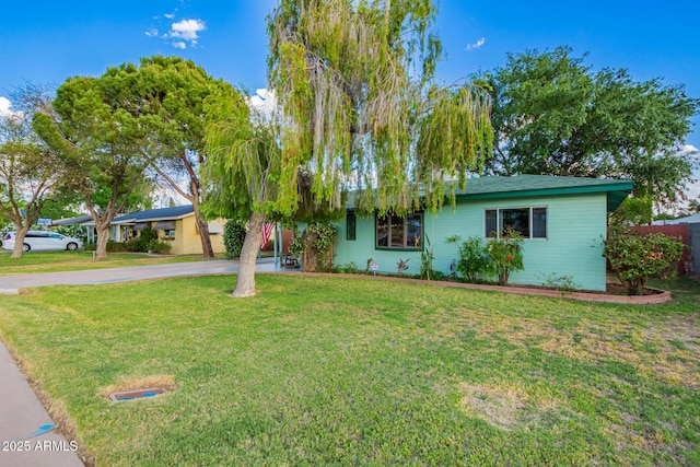 ranch-style house with a front lawn and concrete driveway