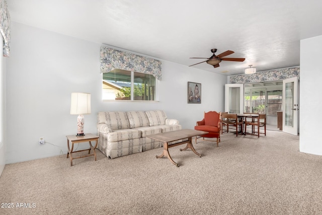 living room with ceiling fan and carpet