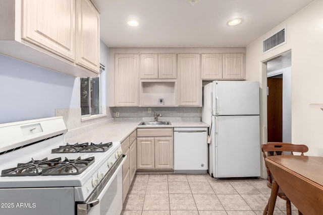 kitchen with visible vents, white appliances, light countertops, a sink, and light tile patterned floors