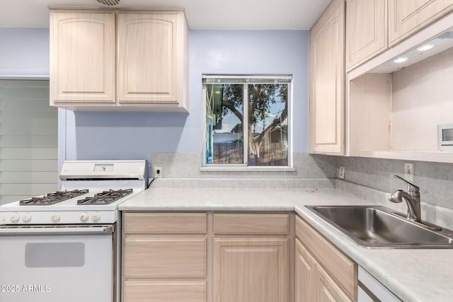 kitchen featuring a sink, light brown cabinetry, white appliances, and light countertops