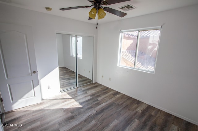 unfurnished bedroom featuring wood-type flooring, ceiling fan, and a closet