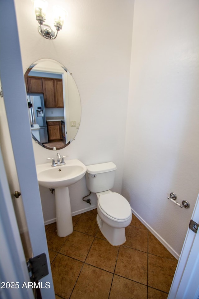 bathroom featuring tile patterned flooring, sink, and toilet