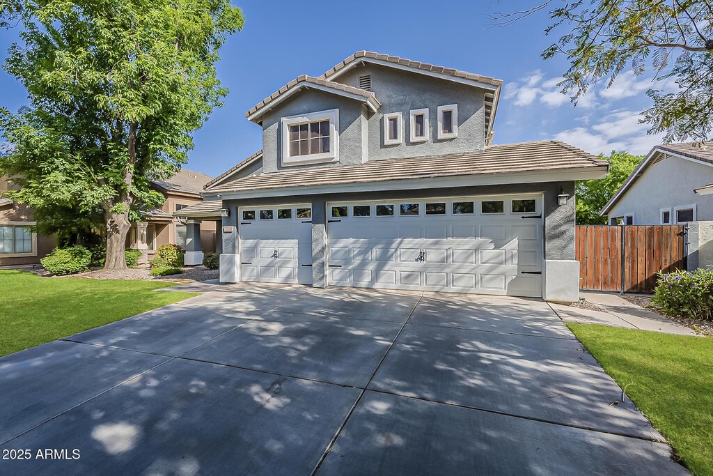 3252 E Lexington Ave, Gilbert, AZ 85234 - traditional home with a garage, driveway, stucco siding, and a tiled roof