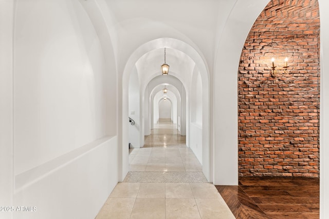 hallway with arched walkways and brick wall