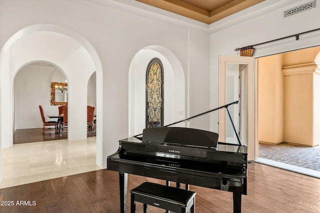 living area featuring visible vents and hardwood / wood-style flooring