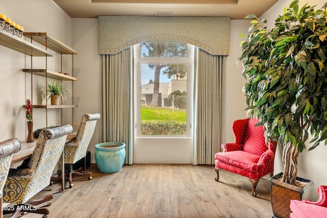 living area with hardwood / wood-style flooring