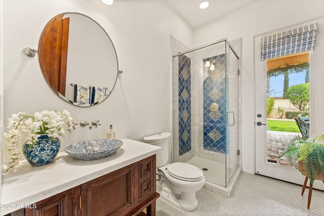 full bath featuring toilet, a shower stall, vanity, and tile patterned floors