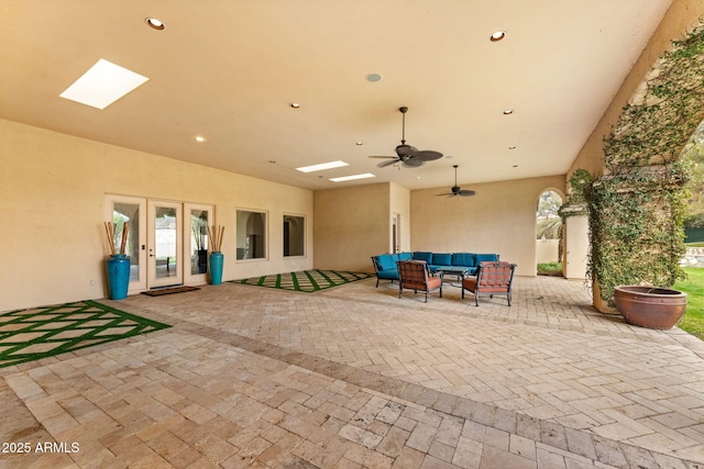 view of patio with ceiling fan and an outdoor living space