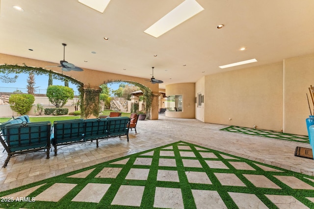 view of patio / terrace with outdoor lounge area, fence, and a ceiling fan