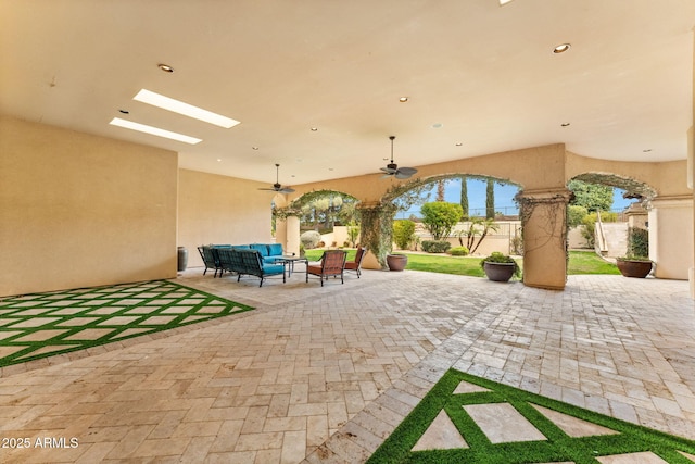 view of patio with ceiling fan, outdoor lounge area, and fence