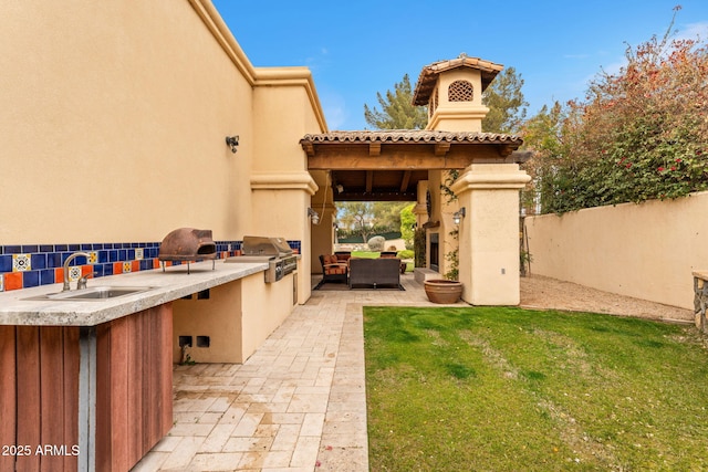 view of patio / terrace with a sink, grilling area, area for grilling, and fence