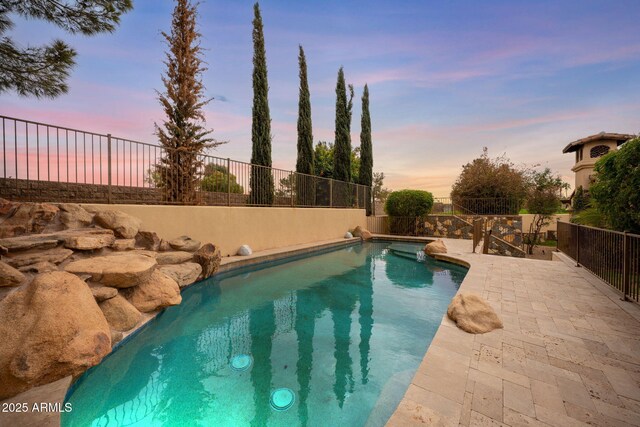 view of swimming pool featuring fence, a fenced in pool, and a patio