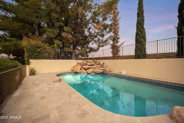 pool at dusk with fence, a fenced in pool, and a patio