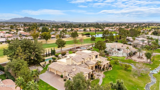 aerial view with a residential view, a mountain view, and golf course view