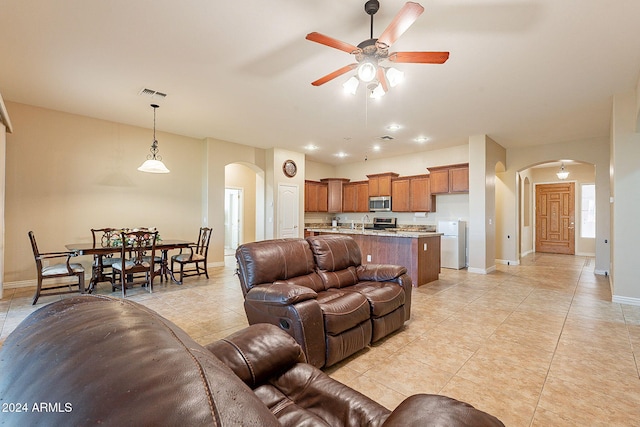 tiled living room with ceiling fan