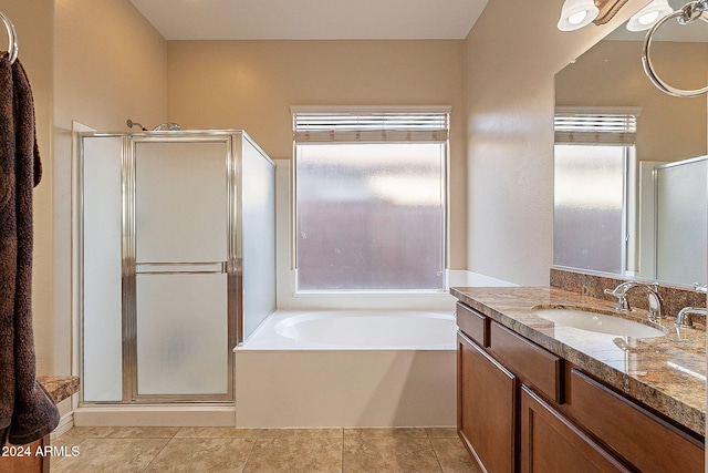 bathroom featuring tile patterned flooring, vanity, independent shower and bath, and a healthy amount of sunlight