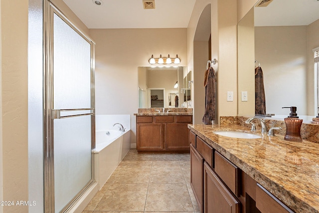 bathroom with tile patterned flooring, vanity, and shower with separate bathtub