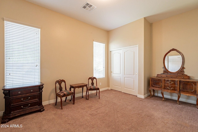 sitting room featuring light colored carpet