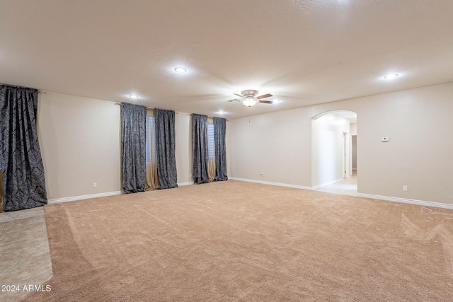 empty room with light carpet and ceiling fan