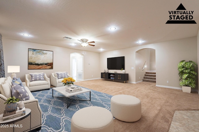 living room featuring ceiling fan and carpet