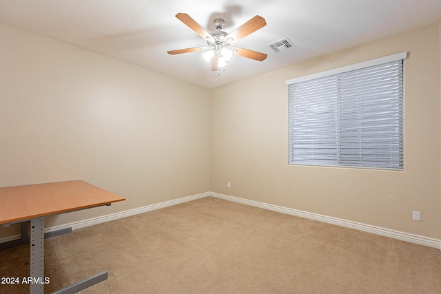 carpeted empty room featuring ceiling fan