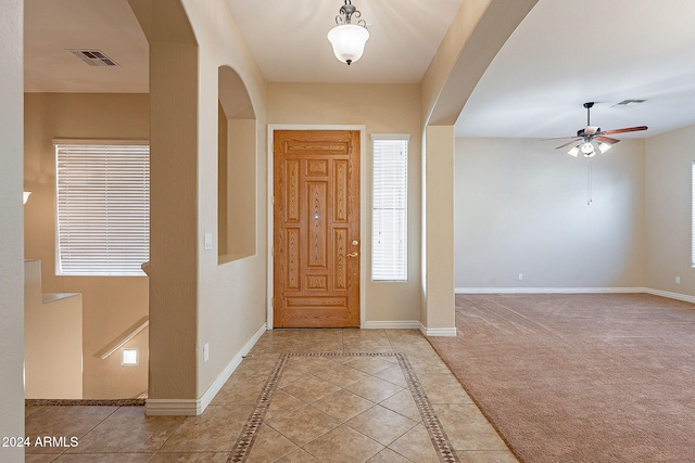 tiled foyer entrance featuring ceiling fan